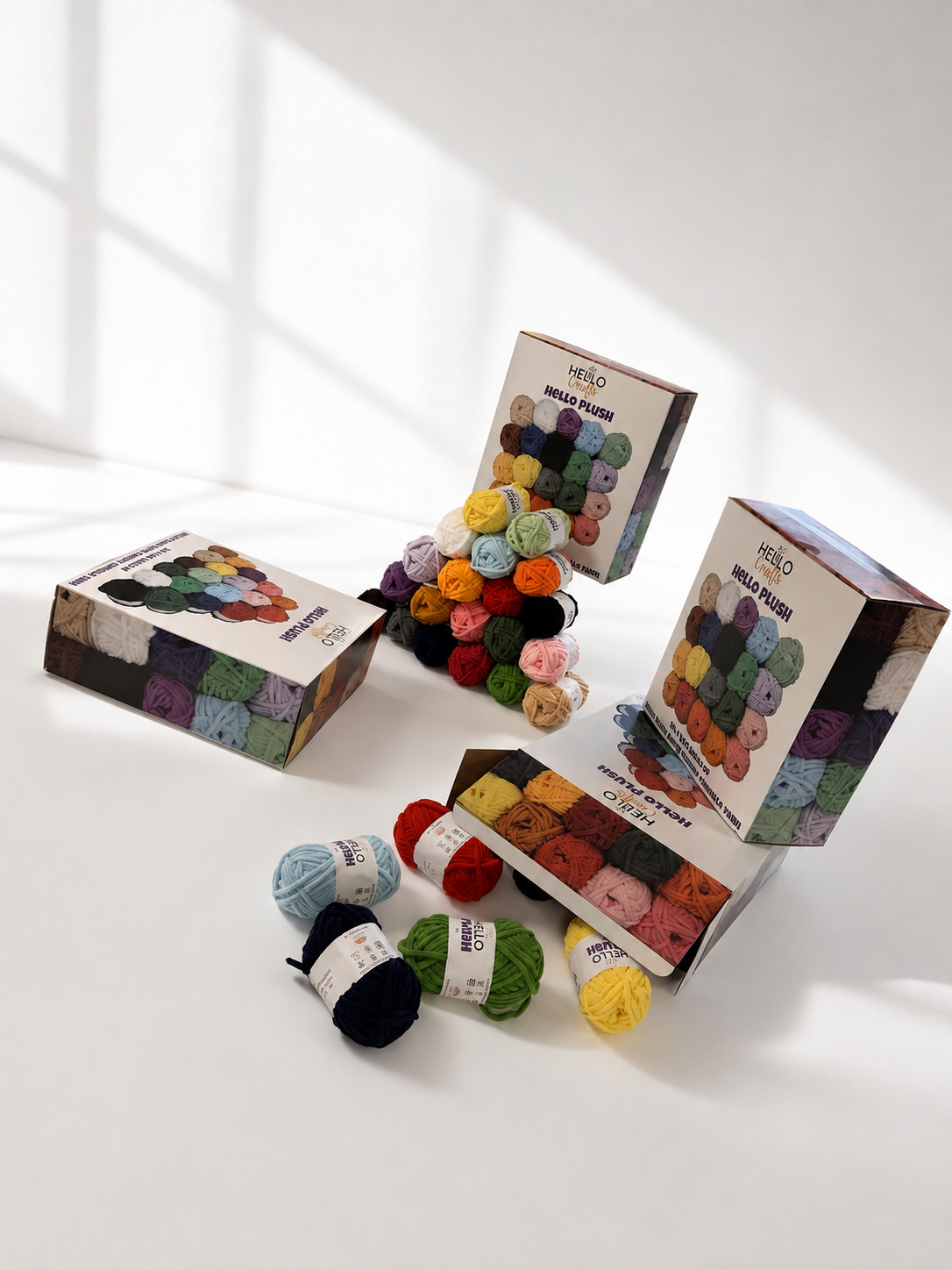 Close up of Hello Plush super chunky chenille yarn balls and box