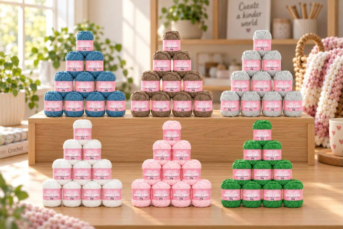 Six packs of 10 Hello Baby Love soft chenille yarn in a craft room - White, Baby Pink, Green, Denim, Brown and Pale Grey